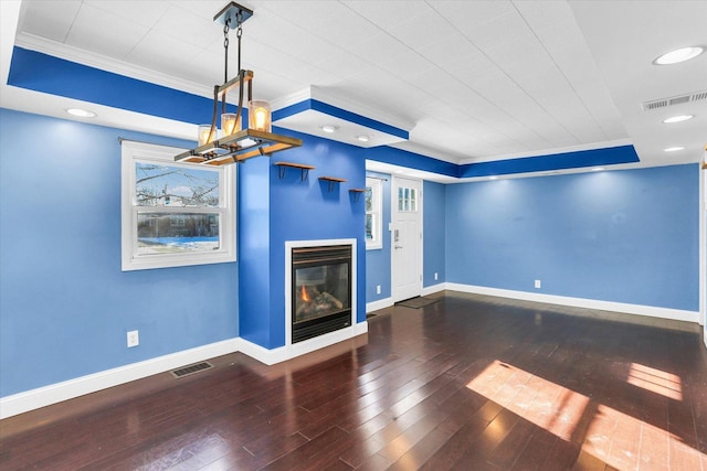 unfurnished living room featuring dark hardwood / wood-style flooring and ornamental molding