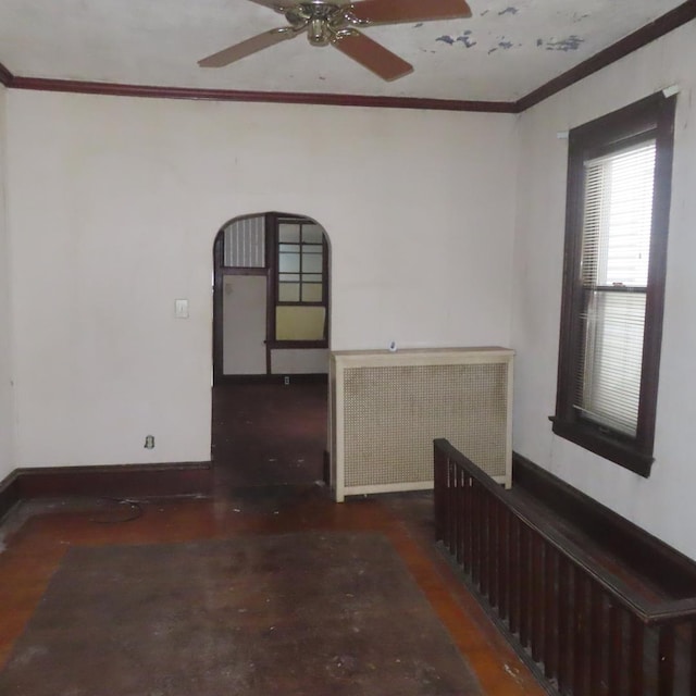 spare room with ceiling fan, radiator heating unit, and crown molding