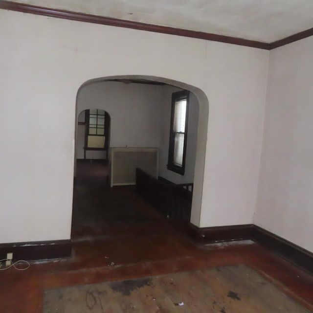 spare room with dark hardwood / wood-style flooring and ornamental molding