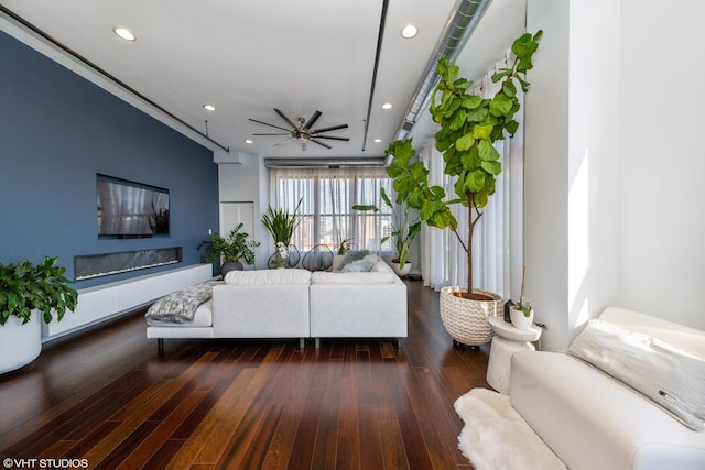 living room with ceiling fan and dark hardwood / wood-style floors