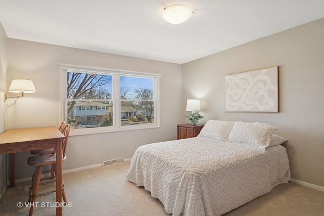 bedroom with light colored carpet, visible vents, and baseboards