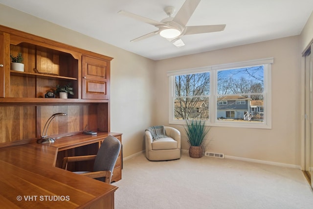 carpeted home office featuring visible vents, a ceiling fan, and baseboards