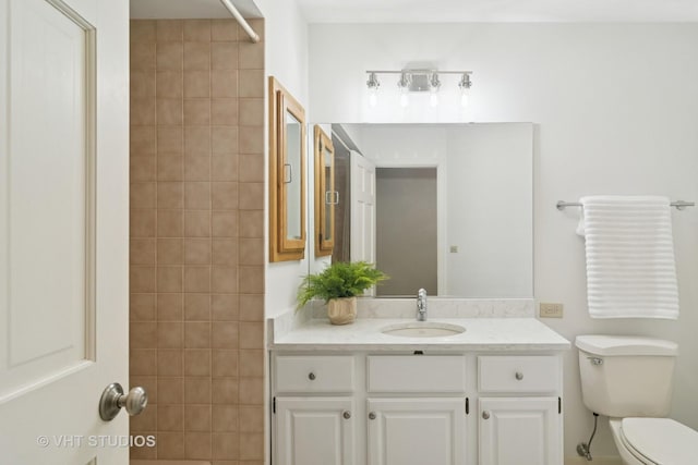 bathroom with toilet and vanity