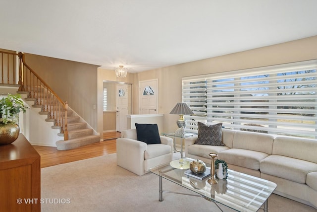 living area featuring wood finished floors and stairs