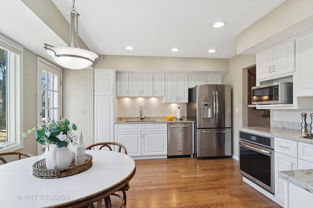 kitchen featuring a sink, white cabinetry, and stainless steel appliances