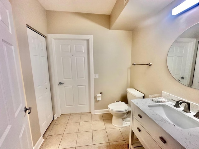 bathroom with vanity, tile patterned flooring, and toilet