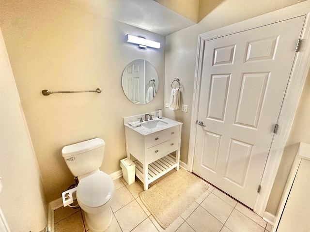 bathroom featuring toilet, tile patterned floors, and vanity