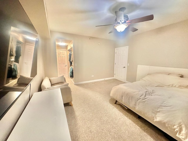 bedroom featuring carpet floors, a closet, ceiling fan, and a spacious closet