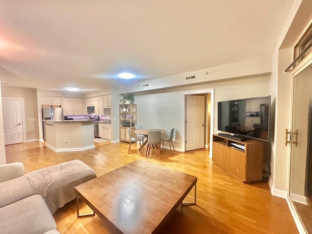 living room with light hardwood / wood-style floors