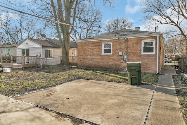 rear view of property featuring a patio area and a wooden deck