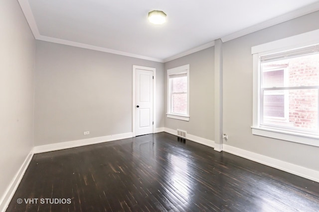 spare room with ornamental molding and dark wood-type flooring