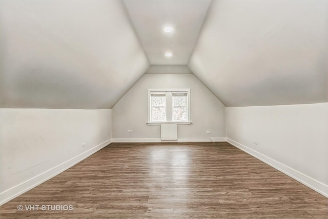 additional living space featuring hardwood / wood-style flooring and lofted ceiling