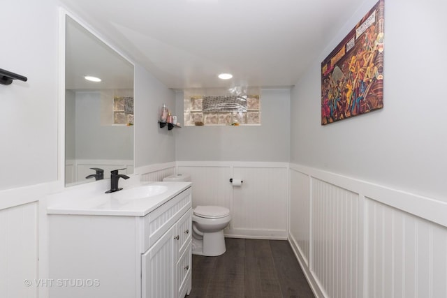 bathroom featuring wood-type flooring, vanity, and toilet