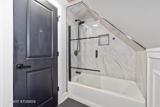 bathroom with bath / shower combo with glass door