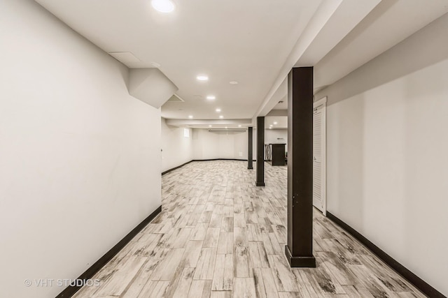 basement with light hardwood / wood-style flooring