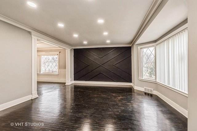 unfurnished room featuring dark wood-type flooring and ornamental molding