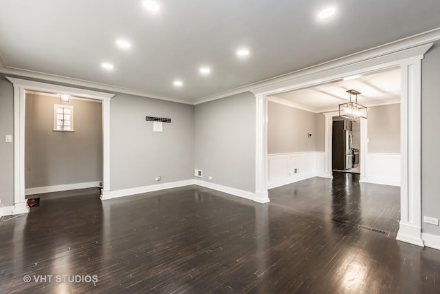 empty room featuring crown molding and dark hardwood / wood-style floors