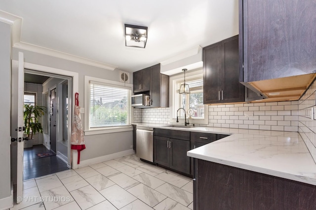 kitchen featuring dishwasher, sink, decorative light fixtures, dark brown cabinets, and light stone counters