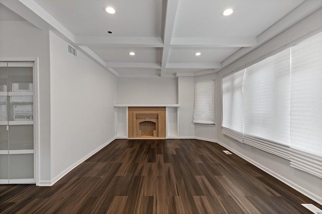 unfurnished living room with beamed ceiling, dark hardwood / wood-style flooring, and coffered ceiling