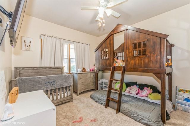 bedroom featuring ceiling fan, lofted ceiling, and light carpet