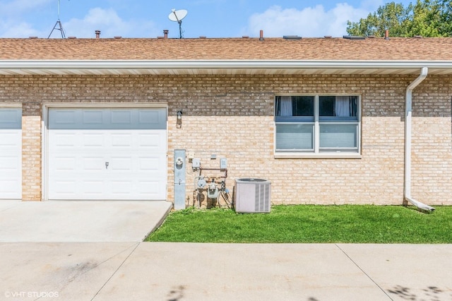 view of front of property with a garage and central AC unit