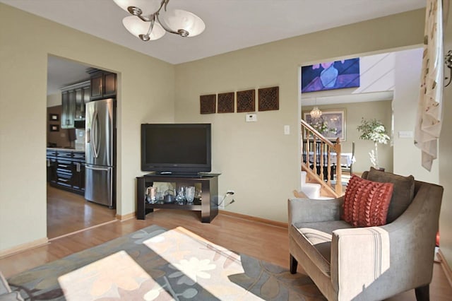 living room featuring a chandelier and wood-type flooring