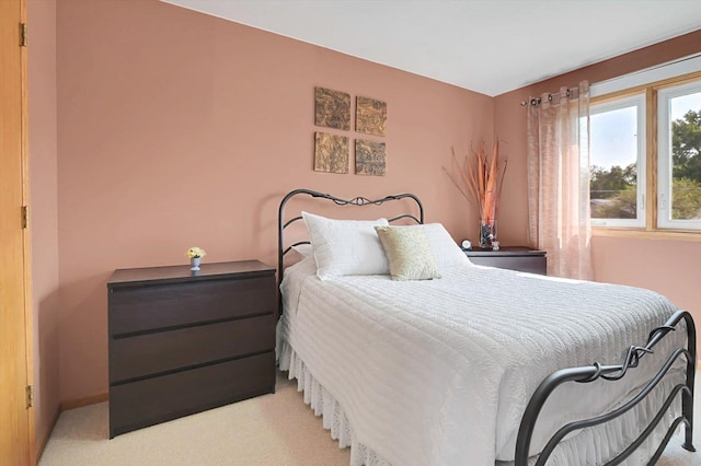 bedroom featuring light colored carpet