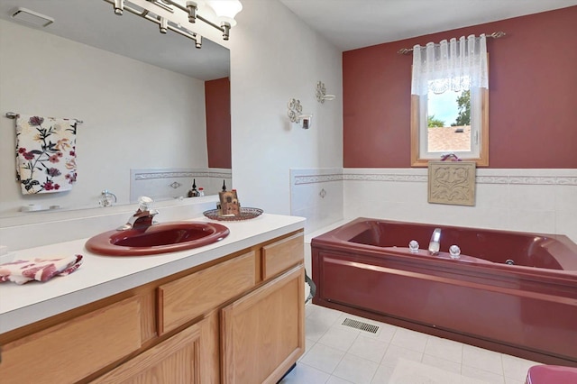 bathroom featuring tile patterned floors, vanity, and a tub to relax in