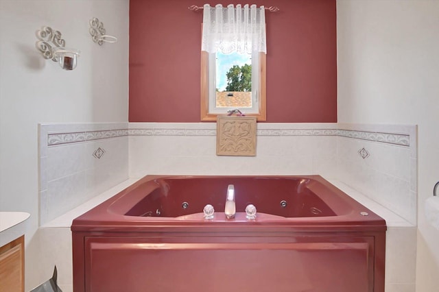 bathroom with vanity and a bath