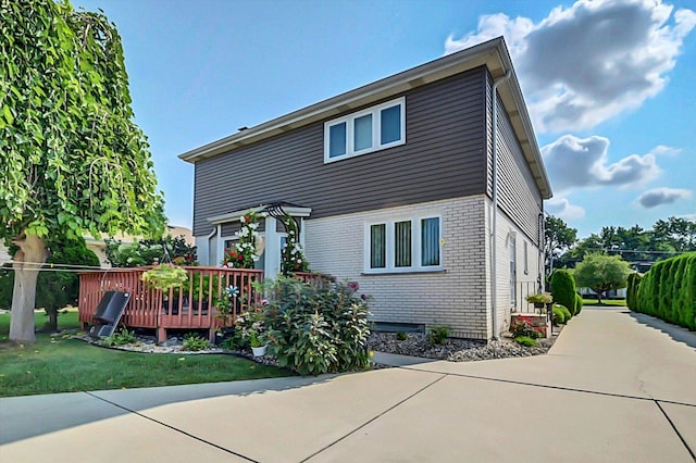 rear view of house featuring a yard and a deck