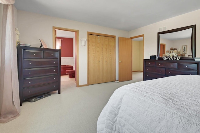 carpeted bedroom with ensuite bath