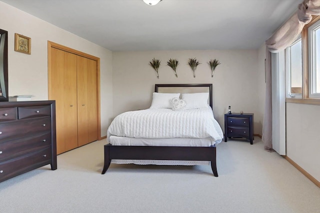 bedroom featuring light carpet and a closet