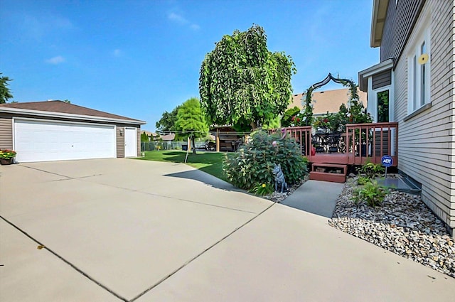 exterior space featuring a garage and a wooden deck