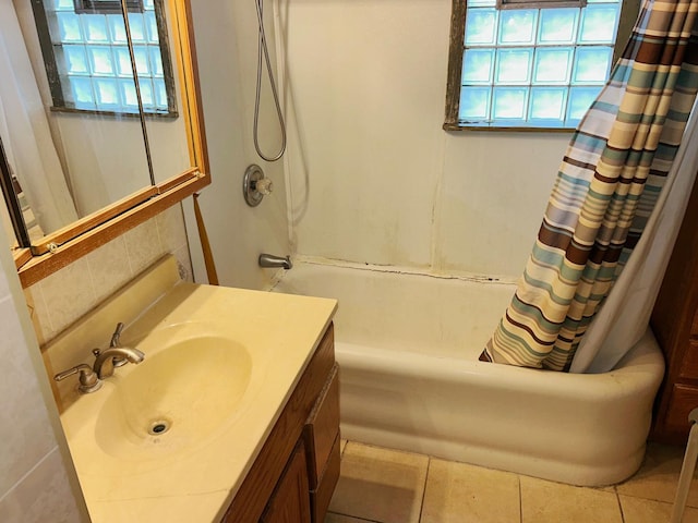 bathroom with tile patterned floors, sink, and shower / bath combination with curtain