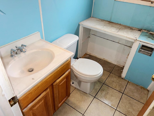 bathroom with tile patterned floors, vanity, and toilet