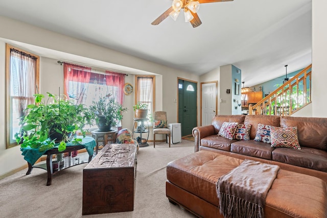 carpeted living room featuring ceiling fan and lofted ceiling