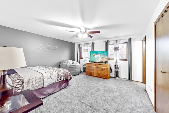 bedroom featuring light carpet and ceiling fan