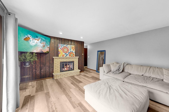 living room with a fireplace and light hardwood / wood-style flooring