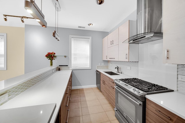 kitchen with light tile patterned flooring, sink, white cabinetry, ventilation hood, and stainless steel appliances