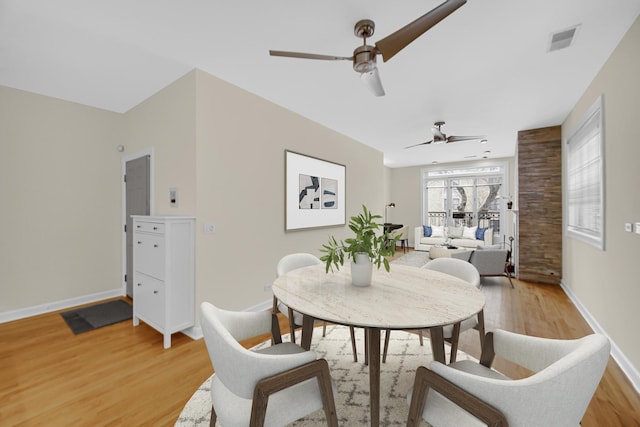 dining room with ceiling fan and wood-type flooring