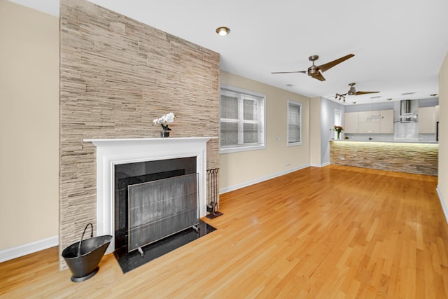 unfurnished living room featuring ceiling fan and light hardwood / wood-style floors