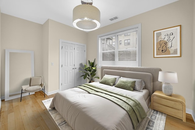 bedroom featuring light hardwood / wood-style floors and a closet