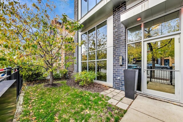 doorway to property featuring a lawn