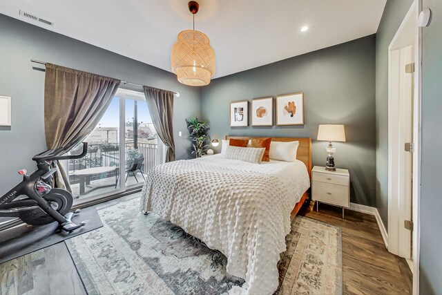 bedroom featuring wood-type flooring and access to exterior