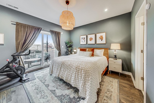 bedroom featuring wood-type flooring and access to exterior