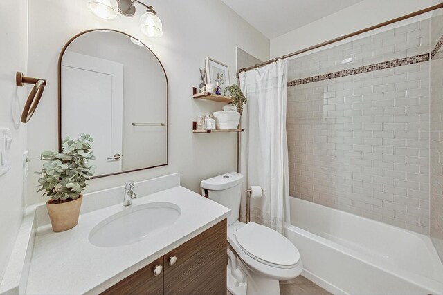 full bathroom with vanity, shower / bath combo with shower curtain, and toilet