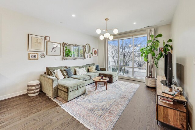 living room featuring hardwood / wood-style floors and an inviting chandelier