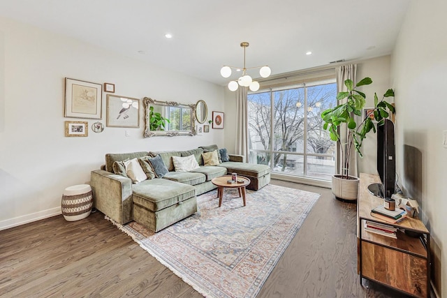 living room featuring hardwood / wood-style floors and an inviting chandelier