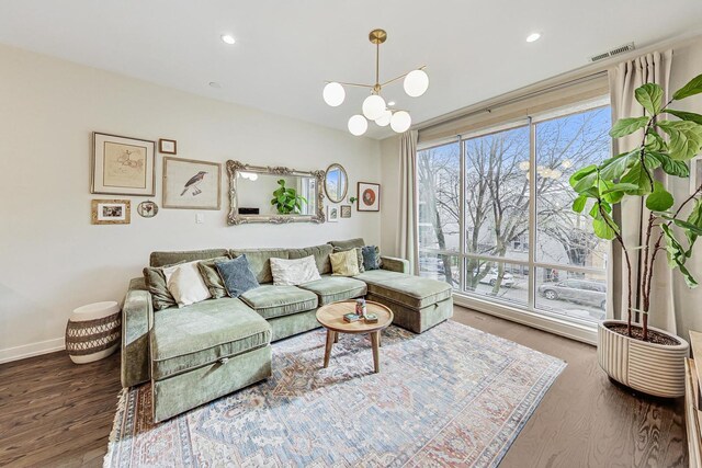 living room featuring a chandelier and dark hardwood / wood-style floors