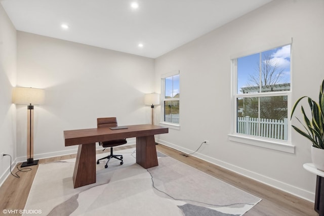 home office featuring a wealth of natural light and light hardwood / wood-style flooring